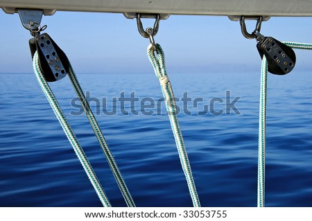 stock-photo-a-photo-of-three-pulleys-ropes-and-yacht-boom-33053755.jpg